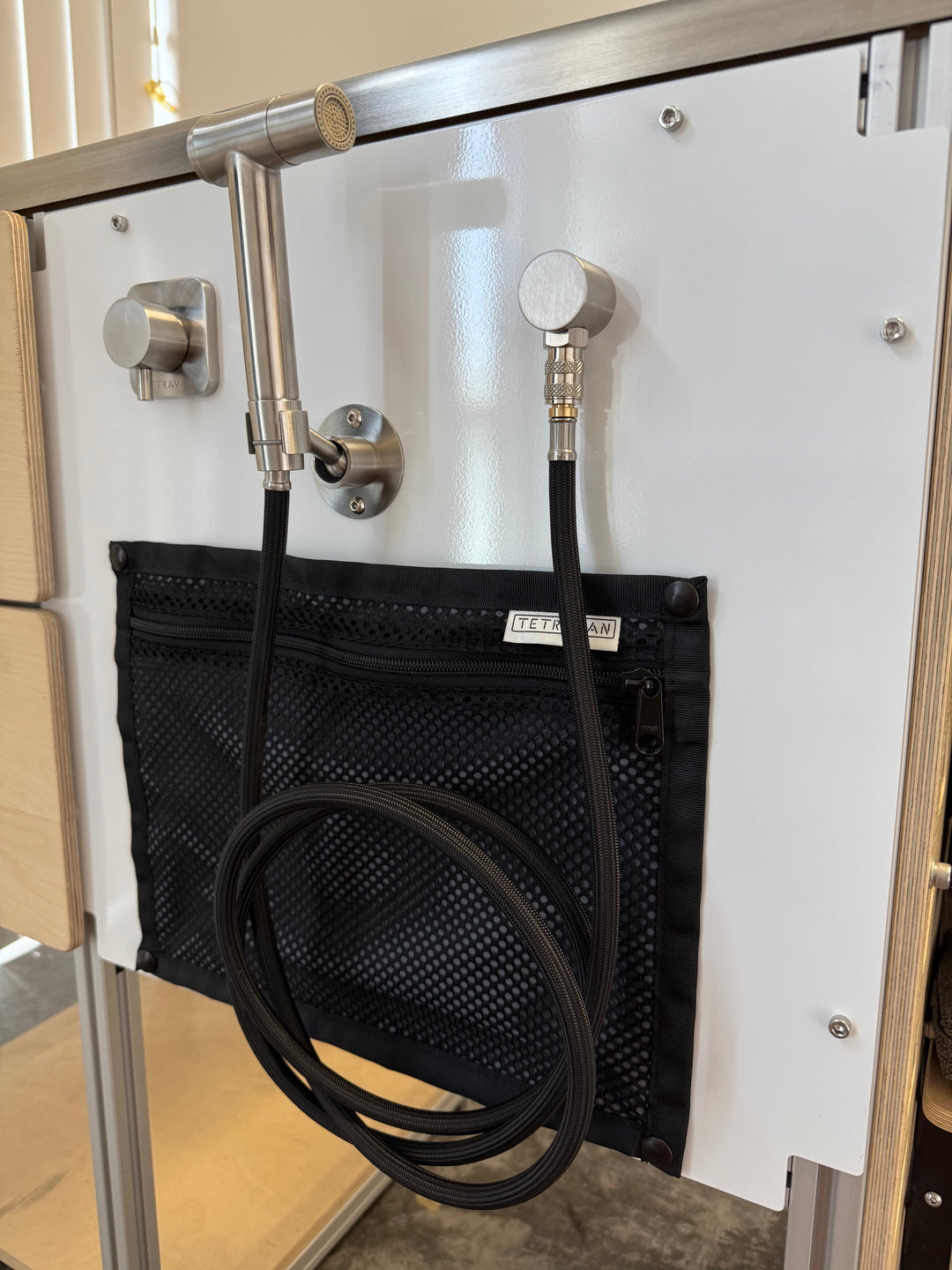 Tetravan shower port with snap on storage pouch